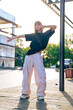 © fotofabrika - Young dancer showcases stylish moves in urban setting during sunset