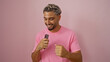 © Krakenimages.com - Handsome young arab man dancing joyfully over an isolated pink background.