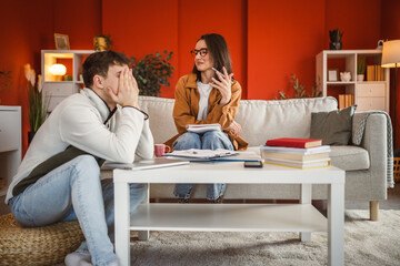 Wall Mural - woman support male colleague while he prepare exam at home