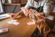 © Miljan Živković - close up on male and female hold and play card on wooden table
