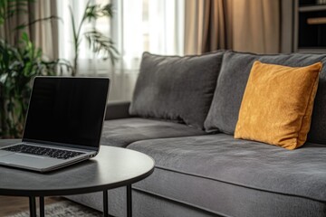 Poster - a person is working on their laptop near a comfortable couch