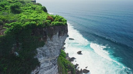 Wall Mural - Rocky cliff coastline near Uluwatu temple in Bali. Drone view, scenic landscape