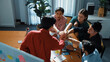 © Summit Art Creations - Top down view of business team putting hand together while discussing about Ux Ui design for mobile phone at boardroom. Close up of marketing team making stack of hand and clapping hand. Convocation.