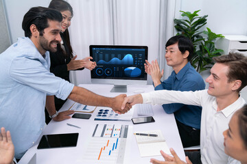 Leinwandbilder - Analyst team leader shake hand with his colleague after successful data analysis meeting using FIntech software power with business intelligence or BI dashboard. Prudent