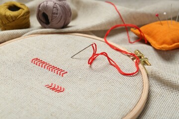 Wall Mural - Embroidery and different sewing accessories on table, closeup