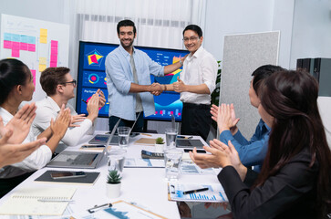 Leinwandbilder - Analyst team leader shake hand with his colleague after successful data analysis meeting using FIntech software power with business intelligence or BI dashboard. Prudent