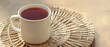 © Pixel-Shot - White mug of hot black tea on wicker mat