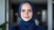 © MAKASIHMAS SIDNEY - Young woman in hijab, confident and smiling, modern interior