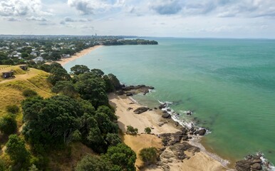 Poster - Aerial view of Cheltenham Beach, with people enjoying the day. Coastal scenery, with a sandy beach and lush green trees. North Head, Devonport, Auckland, New Zealand