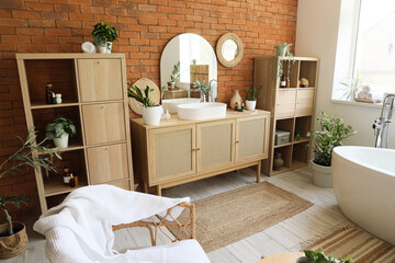 Wall Mural - Interior of stylish bathroom with chest of drawers, armchairs and bathtub