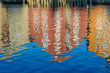 Wall Mural - Reflection of colorful houses in the Nidelva river in Trondheim, Norway