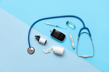 Wall Mural - Modern glucometer with stethoscope, lancet pen, insulin ampule and syringe on color background