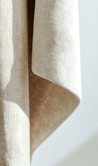 Poster - Natural linen fabric with gentle folds and texture creates soft shadows against white background, showcasing organic textile draping for interior design use.