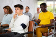© JackF - Small group of mature guys attending the lecture with concern sitting on chairs in light room
