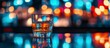© BerkahStock - Glass of liquor on bar counter with blurry colorful lights in background.