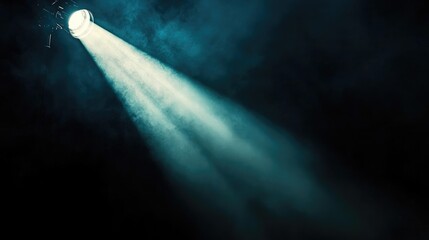 Poster - A film production spotlight casting a focused beam of light in a dark studio, ideal for a background banner with room for copy or branding.