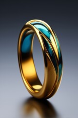 a close up of a gold ring with a blue and green design