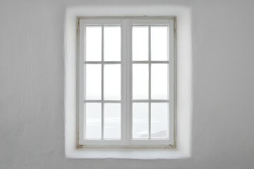 Wall Mural - White framed window centered on a textured white wall