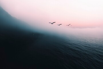 Wall Mural - Birds flying above the ocean. Mountain in background.  Scenic, Travel