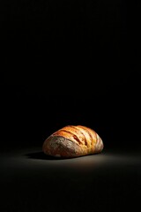 Wall Mural - Loaf of bread on black background. Food photography for restaurant marketing