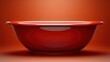 © Idea Library - Elegant red ceramic bowl with glossy finish against a warm orange background