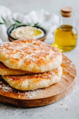 Wall Mural - Flatbread stack on wooden board with hummus and oil for food blog or menu use