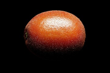 Wall Mural - Close-up of a fuzzy fruit on black for educational materials and food photography