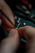 © Sergei - Fingers delicately hold tiny component, showcasing intricate cra