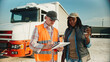 © VAKSMANV - Warm moment of African American female truck driver enjoying her warm drink while talking to inspector or manager. Man in reflective vest asking questions about lorry. Mechanical inspection.