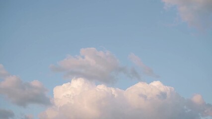 Poster - Pristine white cumulus clouds drifting and morphing against vibrant blue sky backdrop, creating serene and dreamlike meteorological panorama with soft, ethereal movement