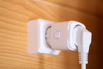 Poster - Close-up shot of a white electrical outlet mounted on a wooden wall.