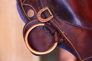 Poster - A close-up shot of a leather bag with a ring attached to it.