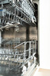 © Elena - open built-in empty dishwasher with shelves extended . High quality photo