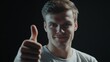 © Oleksandr - Endorsement Gesture: Caucasian Man Showing Thumbs Up in Low Key Approval Scene