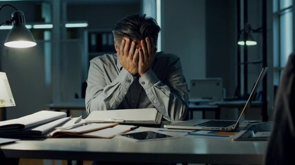 Poster - Stressed office professional experiencing overwhelming workplace pressure, sitting at desk with laptop and documents, covering face while expressing deep mental exhaustion and professional despair