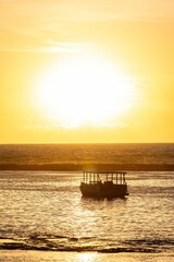 Wall Mural - silhouette of a boat at sunset