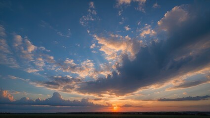 Poster - Dramatic sunset over open landscape with colorful clouds and vibrant sky illuminated by the setting sun in wide panoramic view Copy Space