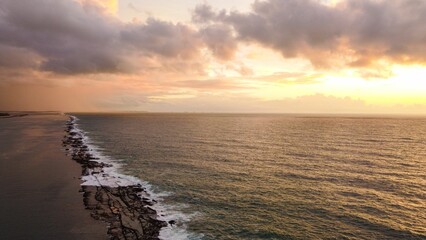 Wall Mural - serene coastal sunset with dramatic clouds.