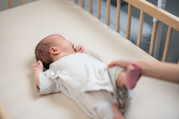 Wall Mural - Mum help baby to do exercise on leg