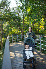 Canvas Print - Mother walking with baby stroller outdoors