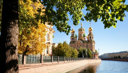 Wall Mural - Canal view of historic church in autumn with sunlit leaves for tourism ads