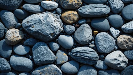 Leinwandbilder - Collection of various shaped and colored smooth pebbles on a flat surface with shadows and textures Copy Space