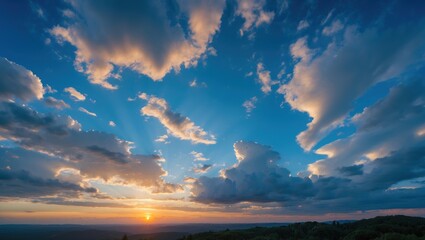 Aufkleber - Sunset over a mountainous landscape with dramatic clouds and sky colors featuring rays of light Copy Space