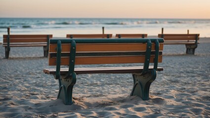 Poster - Wooden park benches facing the ocean at sunset with a sandy beach foreground and soft waves in the background Copy Space
