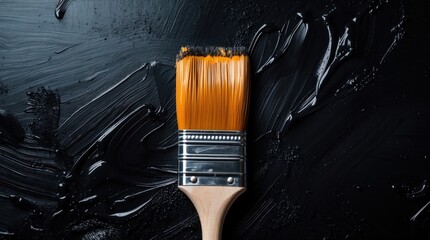 Aufkleber - Paintbrush with orange bristles on a black textured background with paint strokes and copy space for text
