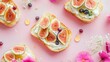 © Nuttaya Nampai - Flat lay of beautifully arranged toasts with cream cheese, sliced figs, currants, and honey on a bright, colorful brunch setting