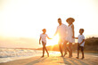 © New Africa - Happy family on sandy beach near sea at sunset
