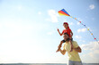 © New Africa - Happy father and his child playing with kite on sunny day. Spending time in nature