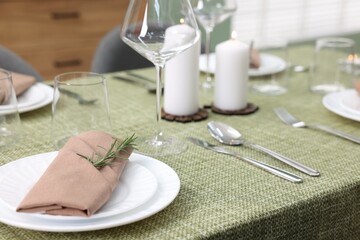 Wall Mural - Stylish table setting with olive tablecloth, glasses and candles indoors, closeup