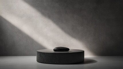 Wall Mural - Dark stone on circular platform, sunlit minimalist background.